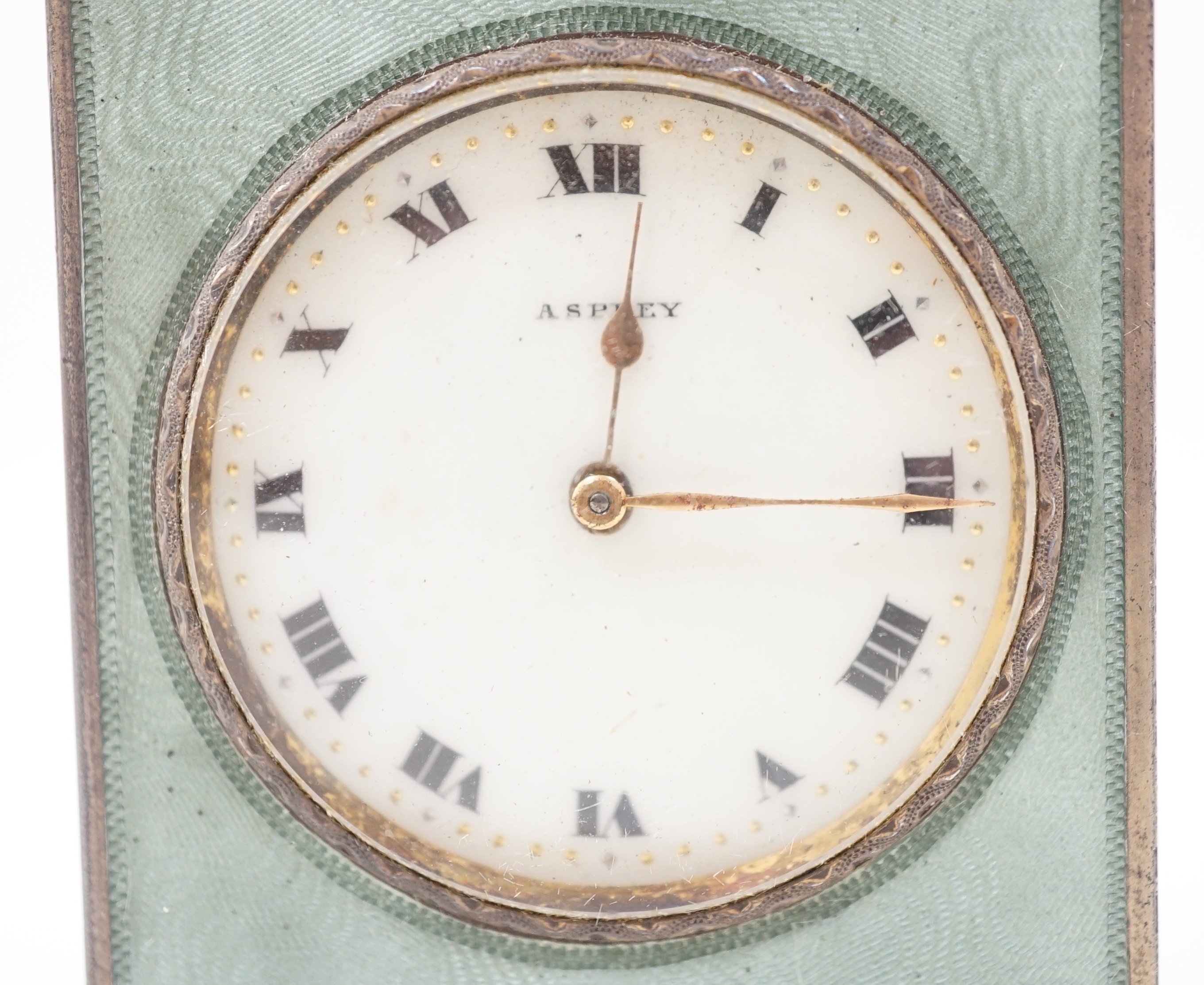 A George V silver and green guilloche enamelled travelling timepiece, retailed by Asprey, in original case